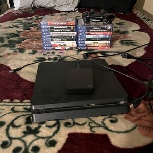 Black ps4 slim 1TB, with 17 games and a 4.6TB storage device controller & cords